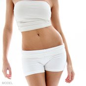 Torso view of woman wearing a white bandeau and shorts that show off her trim, curvy waist and flat tummy.