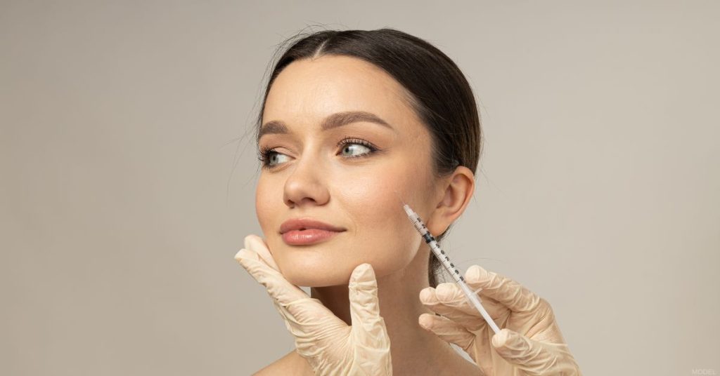 Woman receiving a neuromodulator treatment (model)