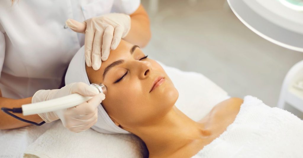 Woman receiving a laser treatment (models)